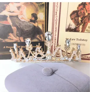 Exquisite gold bridal tiara featuring sparkling rhinestones and pearls for elegant wedding styles.