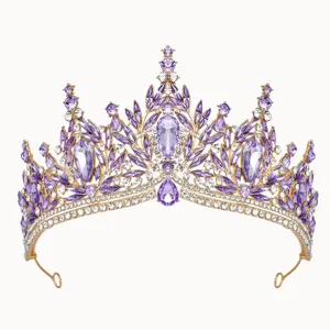 Detailed close-up of a sparkling gold tiara encrusted with purple and clear crystal rhinestones.