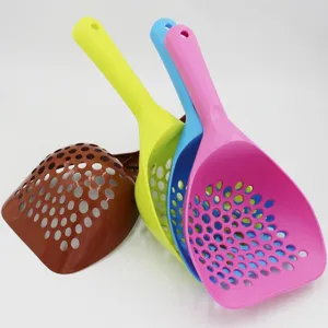 Detailed view of thick plastic cat litter scoop with long handle and sieve holes.
