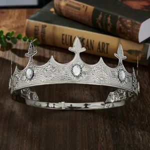Detail shot of vintage silver king crown, showing exquisite metal carving and crystal rhinestones.
