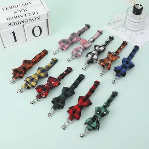 Detailed view of various colorful British plaid pet bow-tie collars with bells