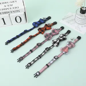 Detailed view of adjustable plaid pet collars with bowties and bells in multiple colors