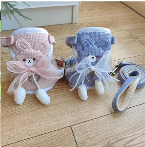 Detailed view of pink and blue rabbit-style pet harness set in waffle knit fabric