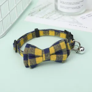 Detail view of the yellow plaid pet collar with a cute bow tie and small silver bell.