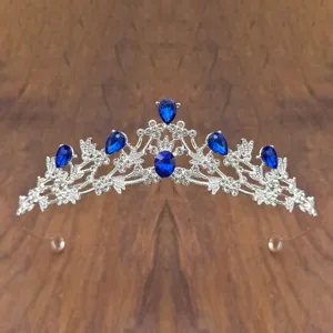Detailed close-up of the elegant silver crystal tiara with deep blue rhinestones.
