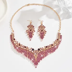 Exquisite crystal necklace and earrings set featuring stunning purple and pink rhinestones.