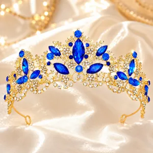 Detailed shot of a luxurious gold baroque tiara with sparkling blue and clear rhinestones.