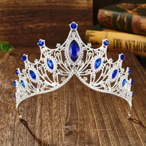 Detailed close-up view of the luxury Baroque silver bridal tiara with blue stones.