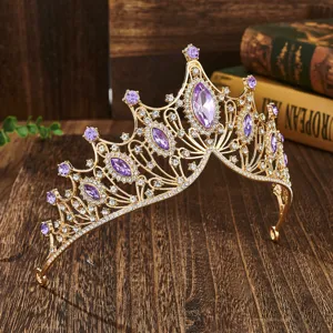 Close up of luxury gold bridal crown with purple rhinestones, vintage baroque wedding tiara.