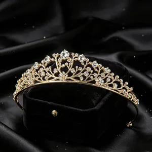 Gold crystal tiara detail closeup, sparkling rhinestones elegant hair accessory for party.