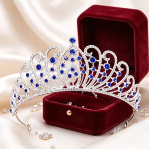 Close-up of exquisite silver tiara with sparkling blue rhinestones and crystal details.