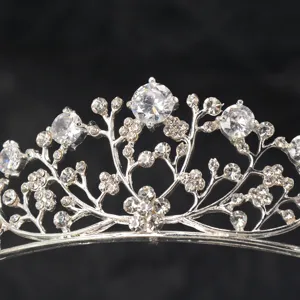 Crystal tiara crown detail featuring sparkling rhinestones on silver metal headband hair accessory.