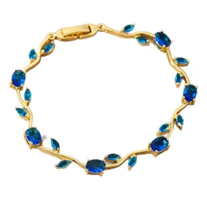 Gold-plated vine bracelet featuring sparkling dark blue cubic zirconia leaf stones.