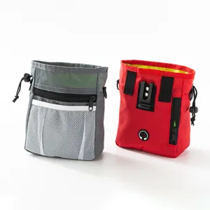 Detailed view of red and grey pet training pouches with metal clips and mesh front pocket.