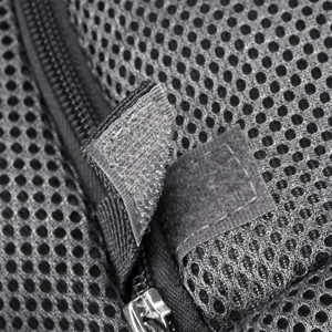 Detailed view of the breathable mesh material and velcro strap on a pet travel carrier