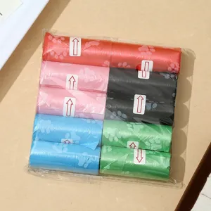 Colorful pet waste bags with cute paw print design, disposable dog poop bags in rolls.