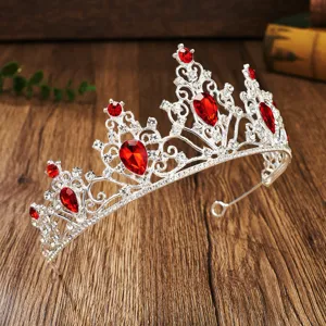Detailed view of the sparkling silver bridal tiara featuring red crystal rhinestones for weddings.