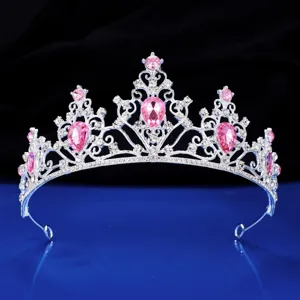 Close-up detail of silver rhinestone princess tiara with pink crystals for wedding party.