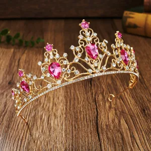 Gold rhinestone tiara detail showcasing sparkling pink crystal stones and intricate metalwork.