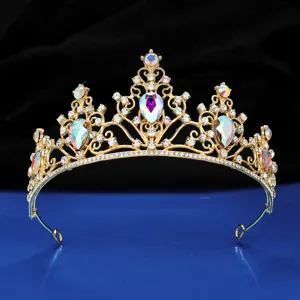 Gold bridal tiara close-up featuring iridescent crystal rhinestones and fine sparkling details.