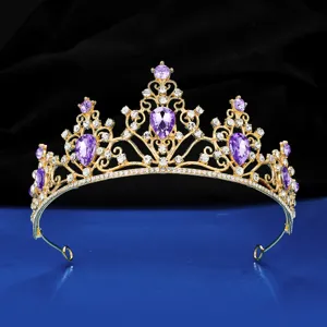 Detailed close-up of a gold bridal tiara crown with purple crystal stones and sparkling rhinestones.