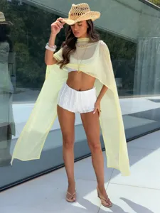 Elegant yellow sheer long chiffon shawl cape for women in a resort style outdoor view