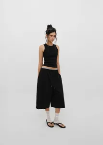 Full body view of women wearing American retro black drawstring loose wide-leg culottes