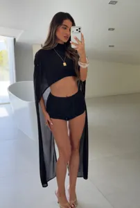 Detailed view of long sheer black chiffon shawl worn over minimalist summer outfit