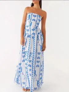Elegant strapless maxi dress with blue and white Mediterranean floral print for summer.