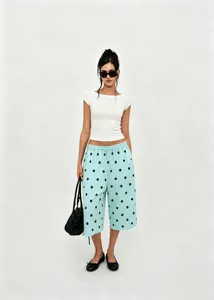 Full view of women's light blue polka dot wide-leg cropped pants with drawstring waist