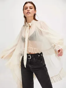 Elegant oversized sheer ruffle shirt with tie-neck, lantern sleeves, and irregular hemline