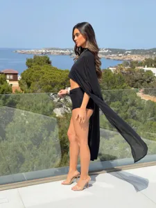 Elegant long black sheer chiffon cape shawl for women shown in a scenic outdoor setting