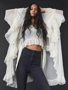 Elegant white sheer ruffled blouse featuring dramatic tiered sleeves and hemline