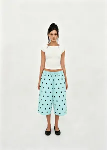 Full body view of casual light blue polka dot wide-leg pants with drawstring waist.