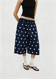 Close-up detail of vintage navy polka dot wide-leg culottes with an adjustable drawstring waist