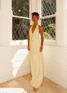 Elegant light yellow satin halter maxi dress with deep V-neck and backless design