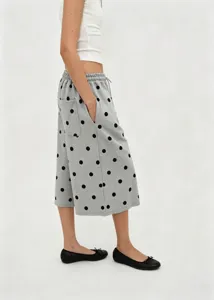 Side view of relaxed grey polka dot wide-leg culottes with drawstring elastic waistline