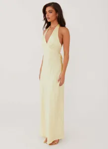 Elegant pale yellow satin maxi dress featuring a sexy V-neck and backless halter design
