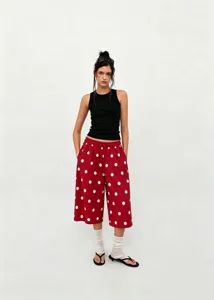 Detailed full-body shot of red polka dot wide-leg cropped pants with drawstring waist