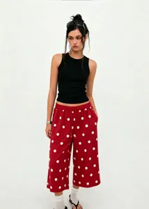 Detailed view of women's red polka dot wide leg pants with drawstring waist and cropped fit.