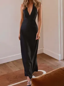Sexy black V-neck halter backless satin maxi dress for women in a chic indoor setting.