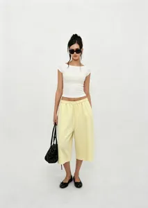 Full view of women's vintage yellow wide-leg cropped pants with drawstring waist