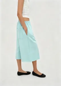 Side view of mint green wide-leg cropped pants with elastic waist and side pocket