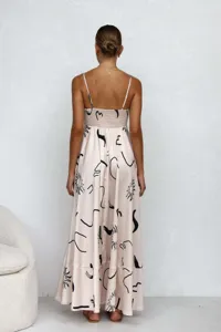 Back view of a high waist spaghetti strap maxi dress with abstract print patterns