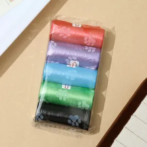 Pet waste bag detail view, colorful dog poop bags with cute paw print design, 5 rolls.