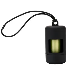 Portable pet waste bag dispenser detail shot, matte black holder with green eco trash bags.