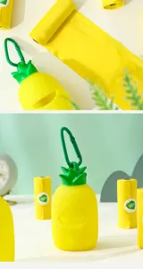 Close-up of a vibrant pineapple-shaped dog waste bag dispenser with yellow rolls
