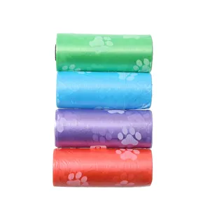 Close-up detail of colorful pet waste dog poop bags with cute paw print patterns, 4 rolls stack.