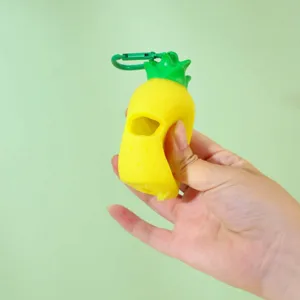 Portable pineapple shaped dog poop bag dispenser with green clip for pet waste cleanup