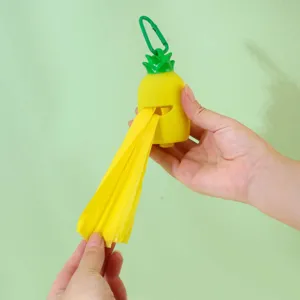 Portable pineapple shaped dog poop bag dispenser with green hook and yellow waste bag